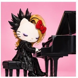 yoshikitty playing a black grand piano with eyes closed